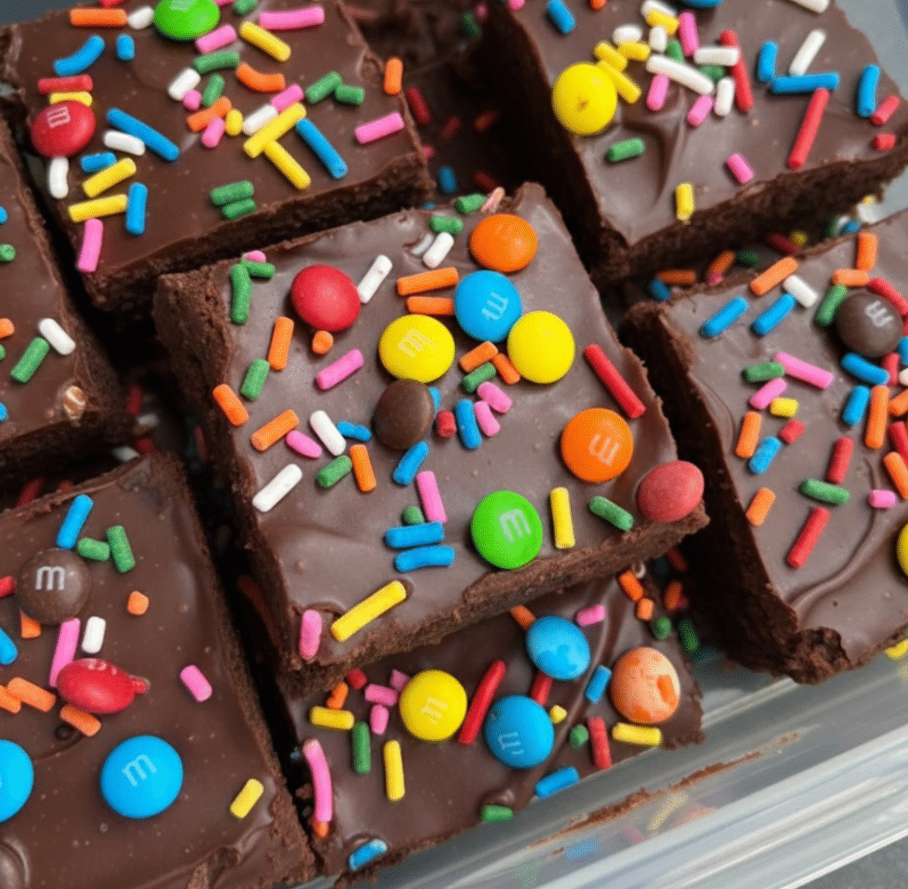 Chewy Christmas candy brown sugar cookies with melted Reese's and crushed M&Ms on a wire rack
