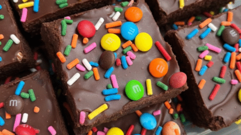 Chewy Christmas candy brown sugar cookies with melted Reese's and crushed M&Ms on a wire rack